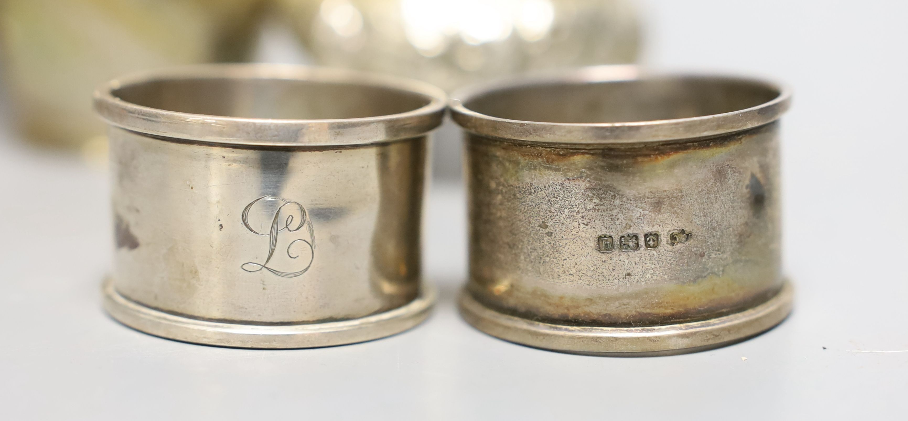 A George III silver cream jug, London, 1806, 10.6cm, a pair of Victorian silver bun salts and four silver napkin rings, 9oz.